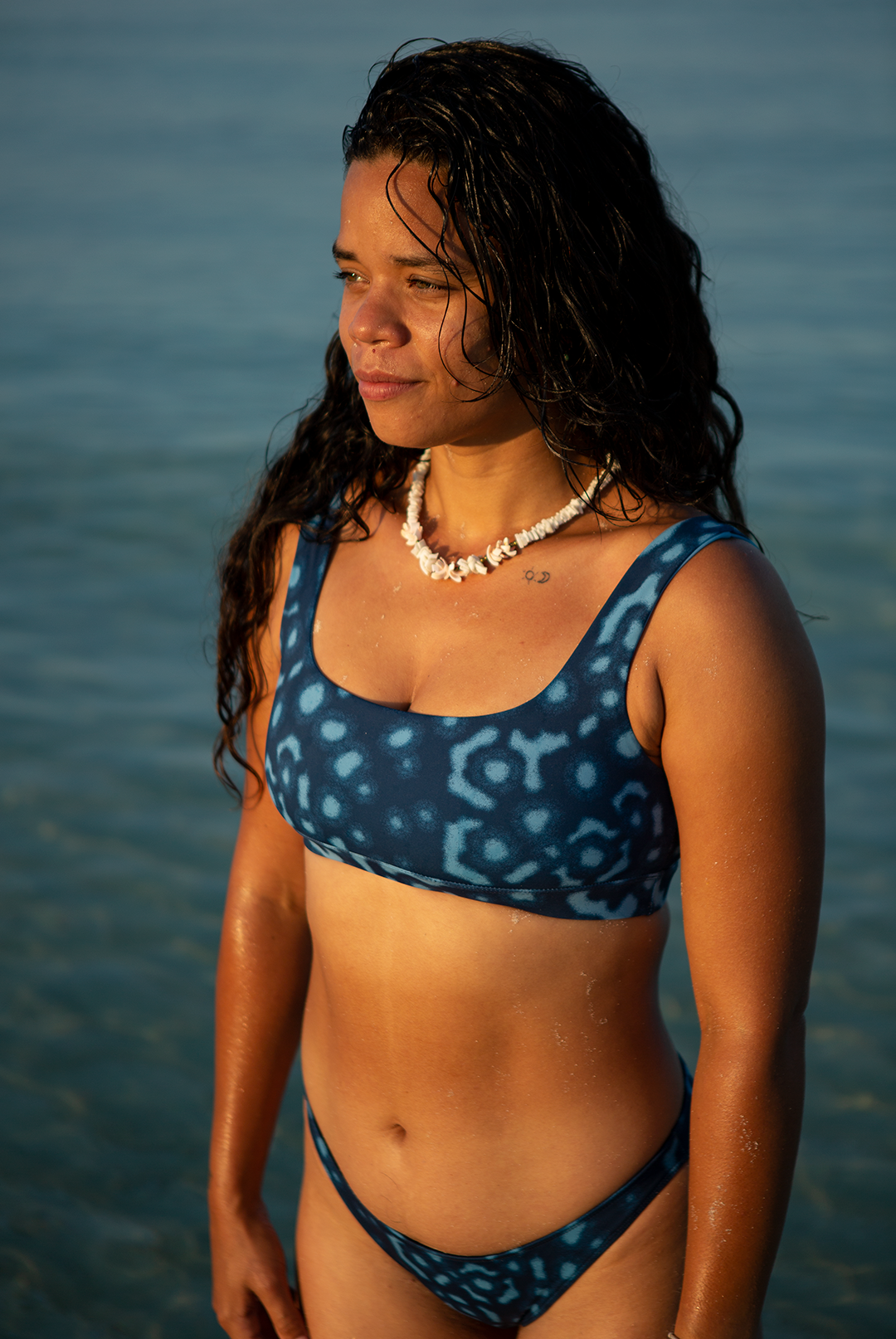 Model wearing eco-friendly Whale Shark swimwear bikini top with blue and white dotted whale shark print, chlorine-resistant scoop neck sports bra style, sustainable swimwear UK.