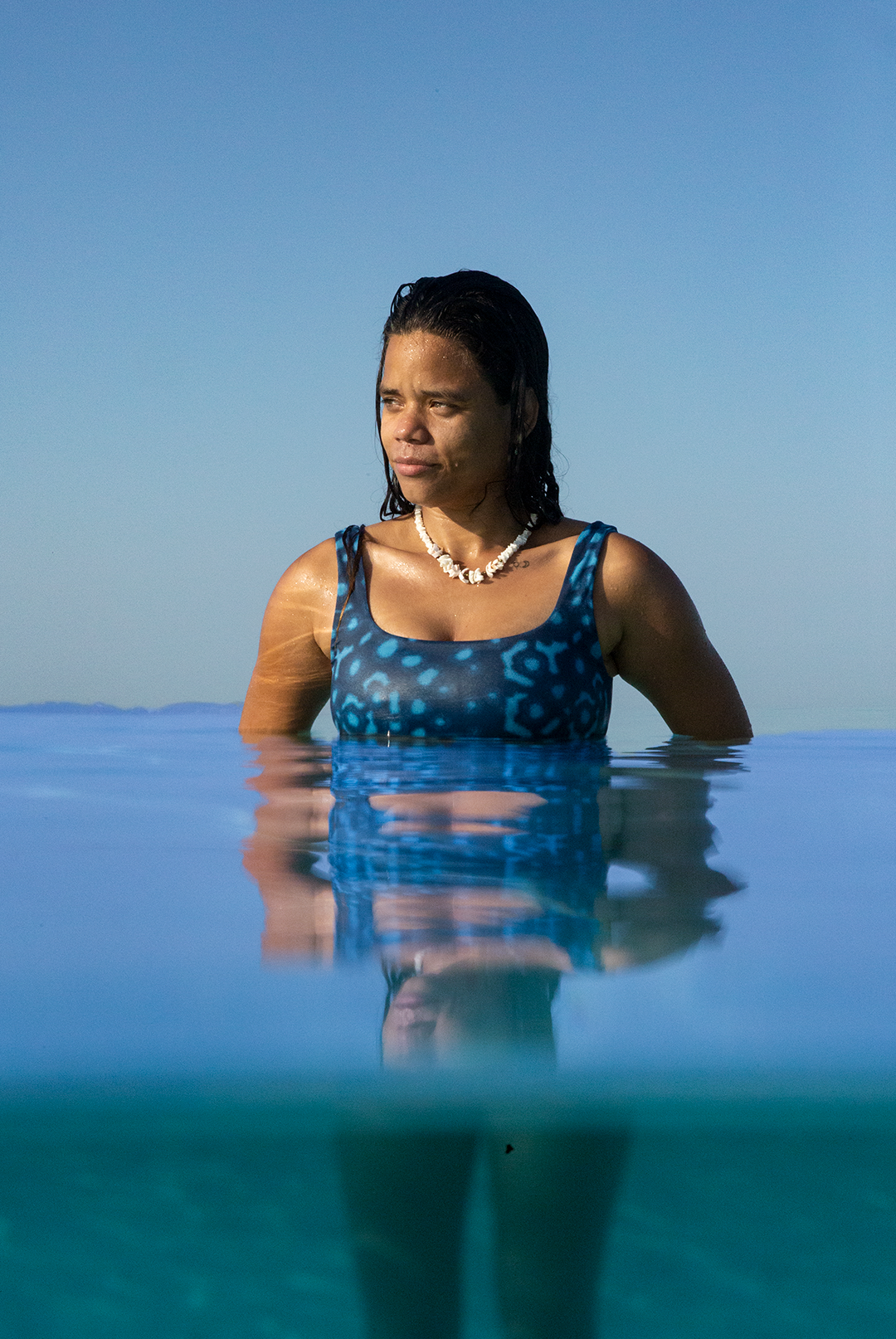 Model wearing eco-friendly Whale Shark swimwear bikini top with blue and white dotted whale shark print, chlorine-resistant scoop neck sports bra style, sustainable swimwear UK.