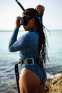 Eagle Ray swimwear long-sleeve one-piece swimsuit with two-tone blue marine animal print, eco-friendly apparel active swimwear, sustainable and stylish surf swimsuit.
