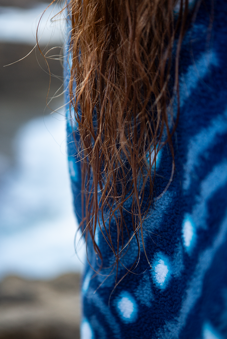 Close-up of the soft recycled fleece fabric showing whale shark spot pattern and sherpa texture.