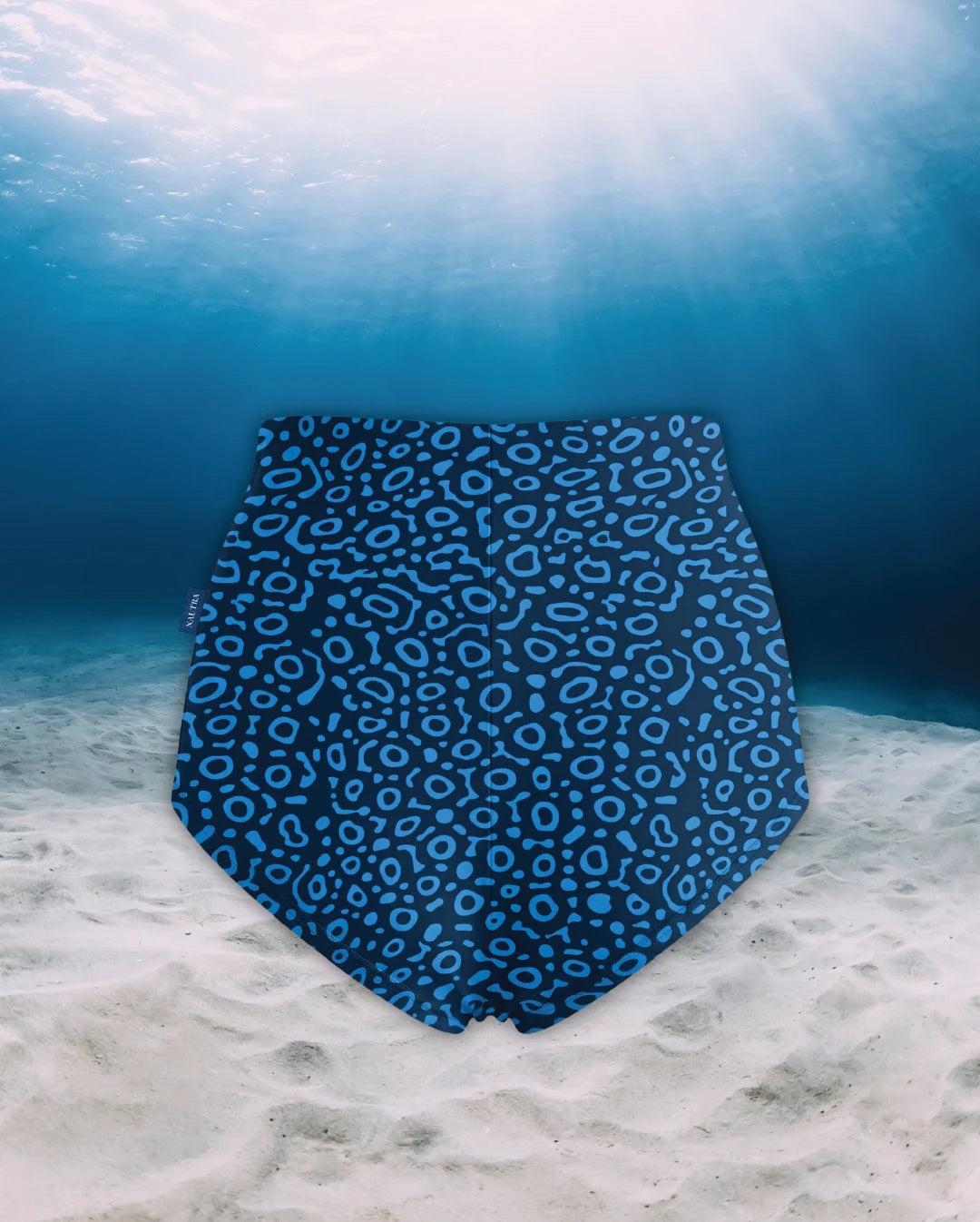 Eagle Ray High Waisted Surf Shorts back view on ghost mannequin, made from recycled fishing nets and designed for movement in and around the water.