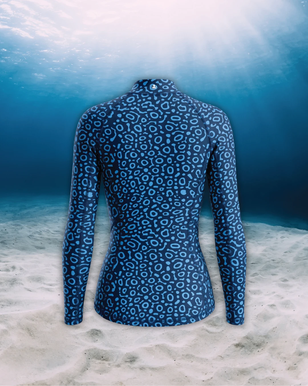 Eagle Ray Long Sleeve Rashguard back view on ghost mannequin, made from recycled fishing nets and designed for movement in and around the water.