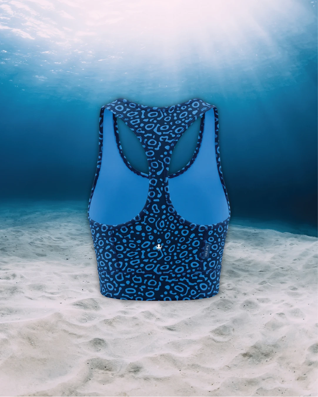 Eagle Ray Racer Back Zip Sports Bra Bikini Top back view on ghost mannequin, made from recycled fishing nets and designed for movement in and around the water.