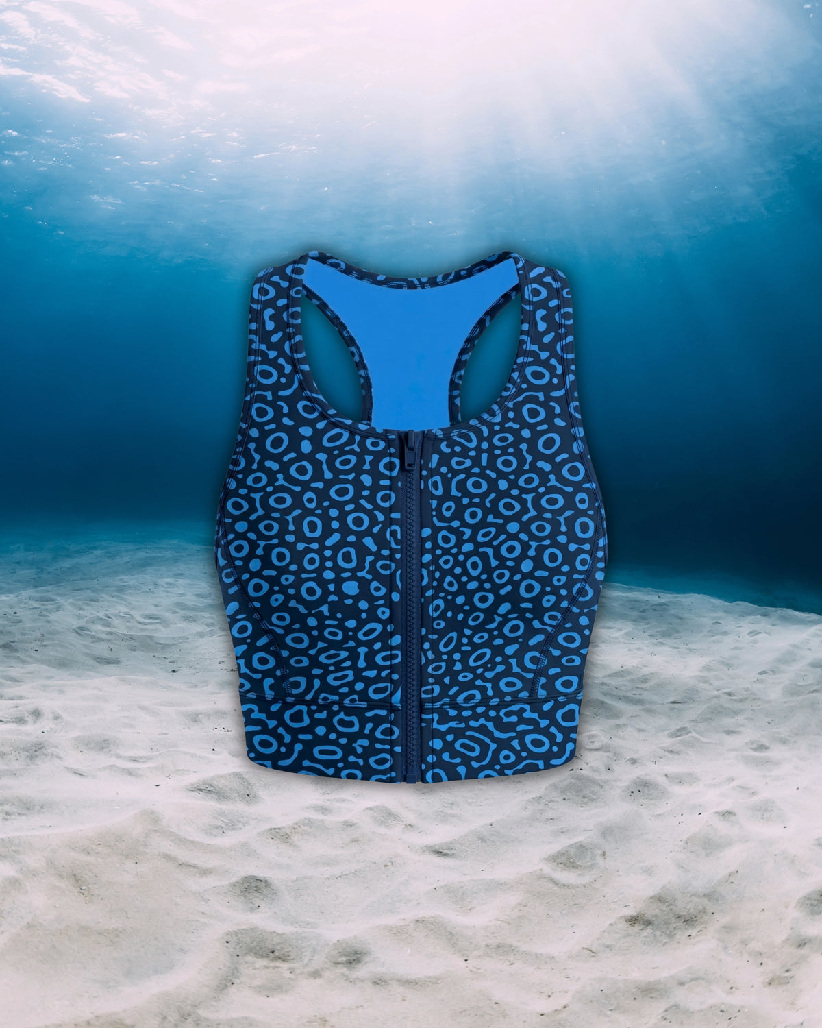 Eagle Ray Racer Back Zip Sports Bra Bikini Front side view on ghost mannequin, made from recycled fishing nets and designed for movement in and around the water.