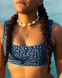 Front view of NAUTRA Eagle Ray Recycled Scoop Neck Sports Bra Bikini Top in ocean-inspired eagle ray print.
