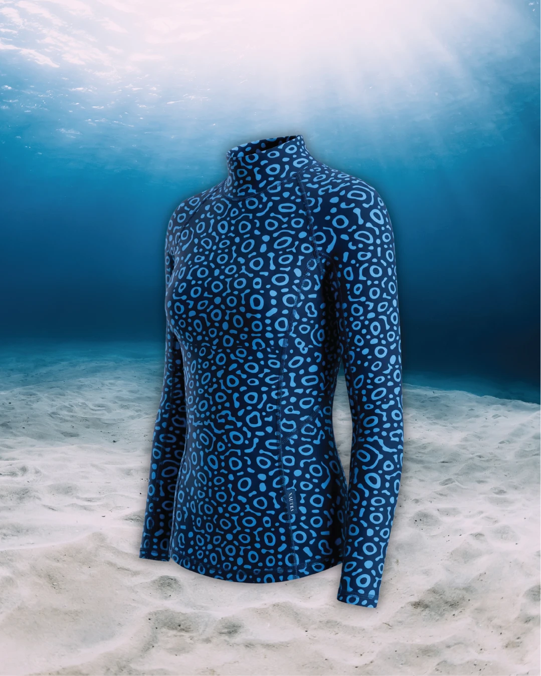 Eagle Ray Long Sleeve Rashguard side view on ghost mannequin, made from recycled fishing nets and designed for movement in and around the water.