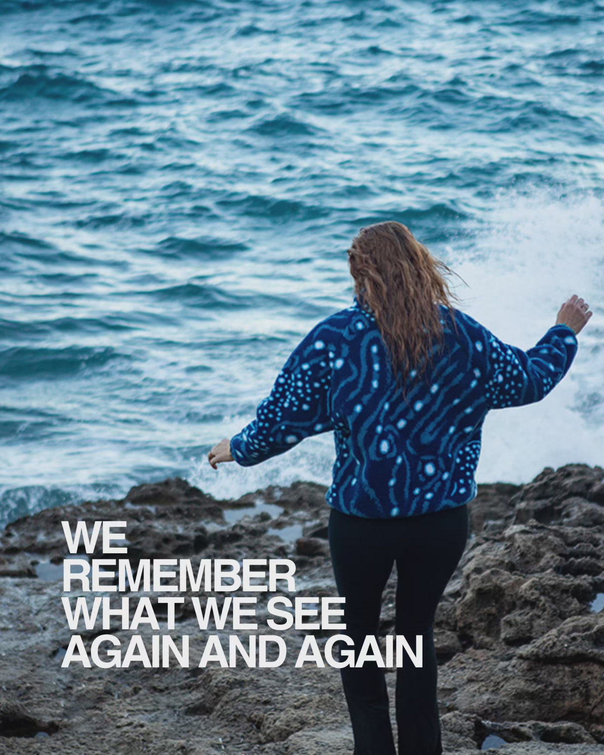 Video showcasing NAUTRA’s Whale Shark Fleece on a rocky coastline with waves crashing against the shore. The model stands by the sea wearing the sustainable, ocean-inspired fleece made from recycled plastic bottles. On-screen text reads: “We remember what we see again and again. Let your fleece be the reason someone remembers the ocean. Be a billboard for the blue.”